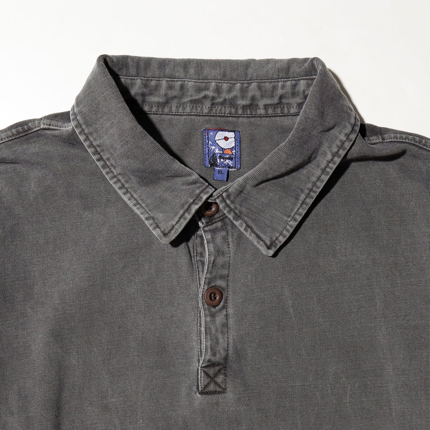 *one-off broken polo shirt, with copper badge