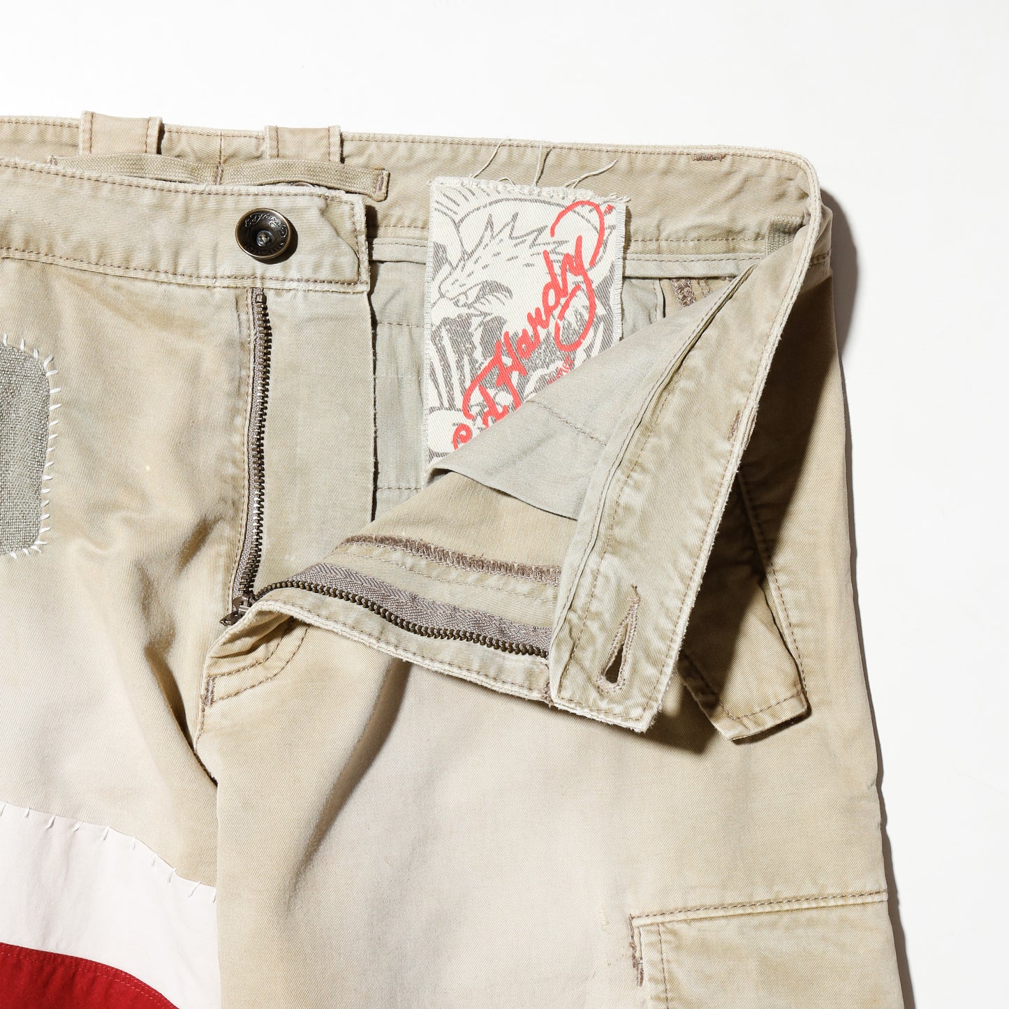 *one-off ed hardy repaired trousers, with copper badge